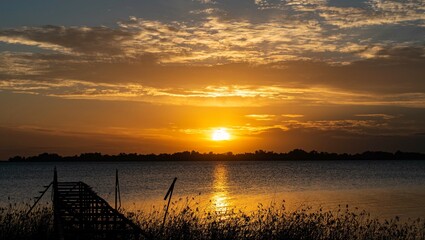 sunset orange over the river whit breakwater