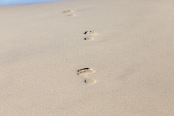 Human footprint on sand summer tropical beach background