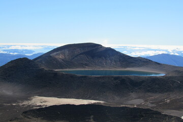 Scenic view of a lake surrounded by rocky hills in Tongariro National Park, New Zealand