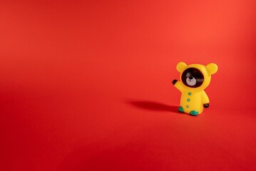 Closeup of animal toy figurine on red background with copy space for text or design