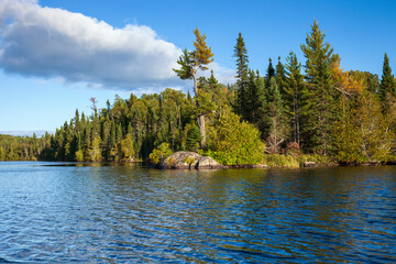Lake in northern Minnesota with rocks and pines along the shore
