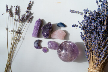Gemstones minerals stones and obelisks with lavender flowers.Witchcraft, herbal medicine and...