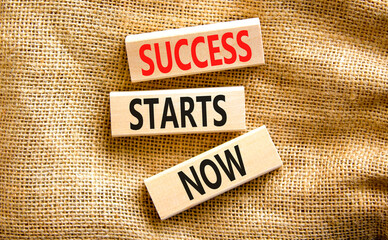 Success starts now symbol. Concept word Success starts now on beautiful wooden block. Beautiful canvas table canvas background. Business motivational success starts now concept. Copy space.