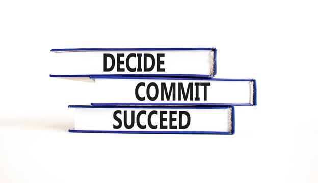 Decide commit succeed symbol. Concept word Decide Commit Succeed on beautiful books. Beautiful white table white background. Business decide commit succeed concept. Copy space.