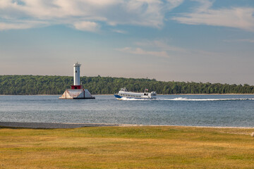 A Ferry Boat Passing the Light House Round Island off Mackinac Island, Lake Michigan  - 650883930