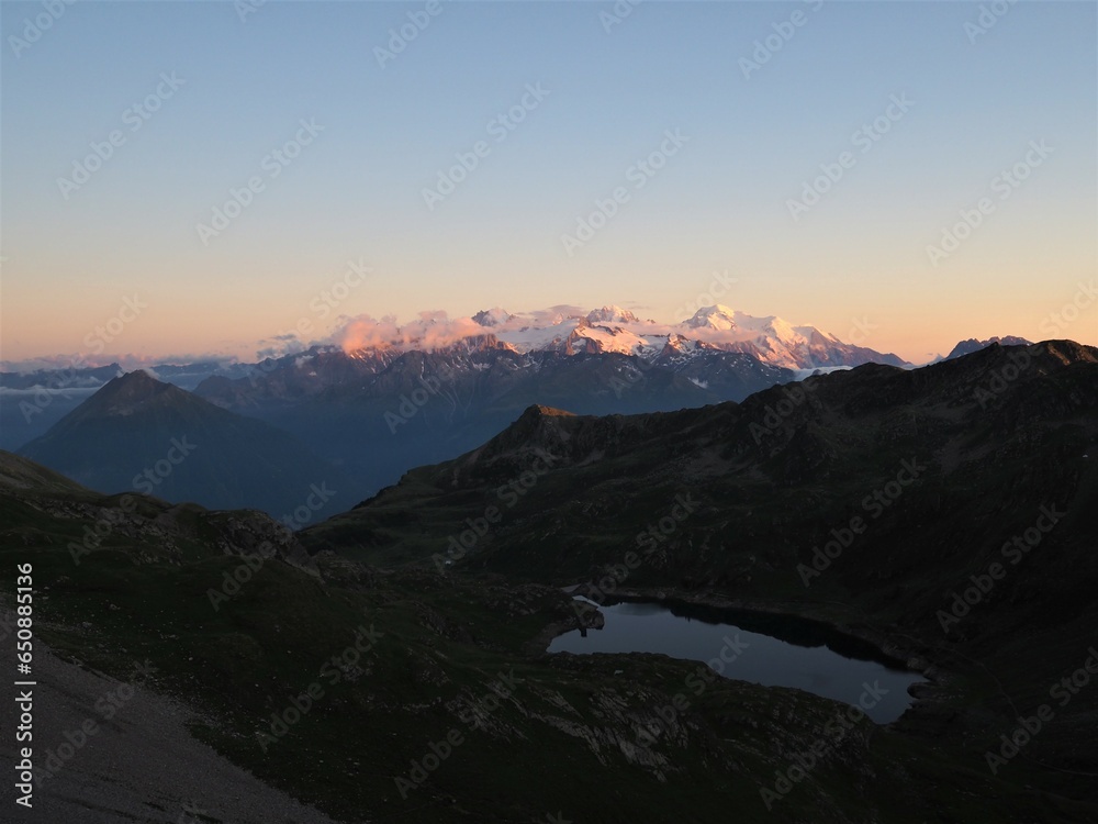 Wall mural Scenic view of a mountainous landscape during a beautiful sunset in a rural area