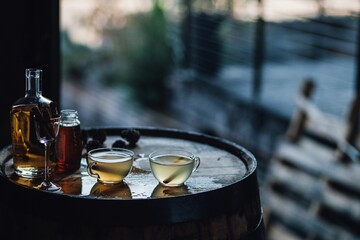 Hot toddy drinks in clear glasses on whiskey barrel