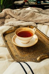 black tea in fancy gold and white teacup