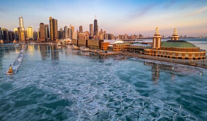Fototapeta premium Aerial Chicago skyline at sunrise with a view of the navy pier and frozen lake Michigan