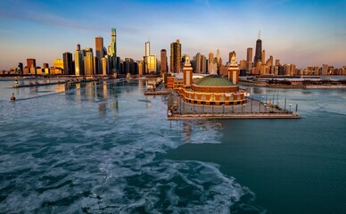 Aerial Chicago skyline at sunrise with a view of the navy pier and frozen lake Michigan
