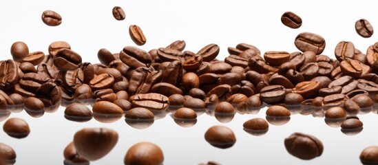 Obraz premium Coffee beans falling on a white background symbolizing breakfast energy freshness and a delightful aroma