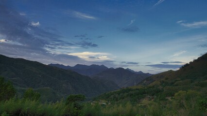 Fototapeta premium a scenic view of a mountain in the distance with clouds