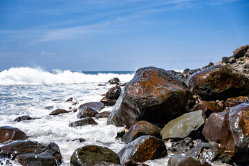 Closeup shot of sea waves crashing against a rocky shore