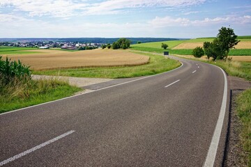 Fototapeta na wymiar Scenic view of a road in a lush field in the countryside in Germany