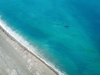 Tranquil blue ocean lapping against a sandy beach