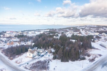Fototapeta na wymiar Aerial view of a winter port and harbor showcasing the waterfront: Cartwright, Canada