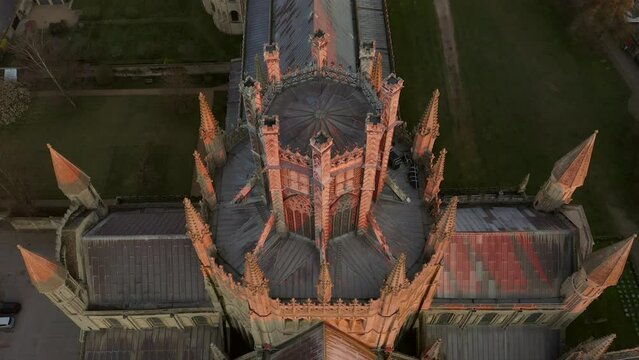 Aerial tilt up reveal view Ely Cathedral in Cambridgeshire. Holy and undivided Trinity Anglican cathedral in UK. Famous travel visit destination in autumn