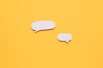 Blank paper speech bubbles on orange background