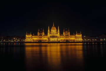 Fototapeta na wymiar parliament building on parliament square lit up at night by the danube river