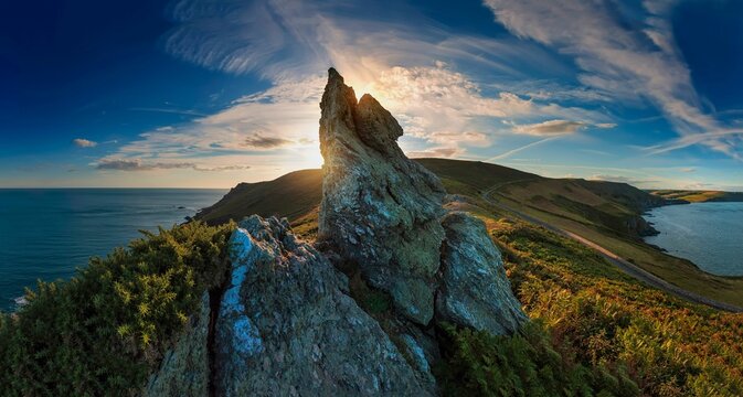 Beautiful sunset over the cliffs and blue sea. Start Point, Devon, England, UK.