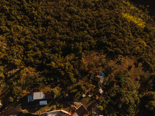 Aerial view of a beautiful landscape with a few buildings in sunny weather