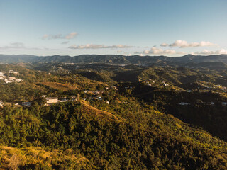 Aerial view of a beautiful landscape with a few buildings in cloudy sky background