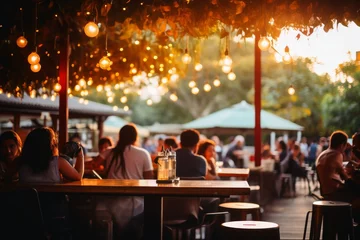 Gordijnen An outdoor bar and restaurant with people. © Michael