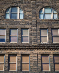 Facade and Arched Windows of an Antique Brown Stone Building.