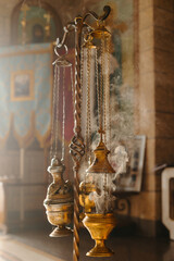 Vertical photo Censer against the background of sunlight in an Orthodox church