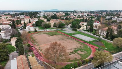 Overhead shot of Montpellier's deserted sports arena with a neglected track.
