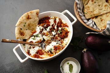 Afghani Doi Begun - Eggplant prepared in tomato sauce topped with seasoned yogurt _ Baigan masala served with Roti
