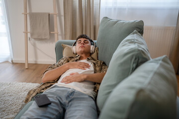 One teen man doing guided meditation yoga self care practice at home