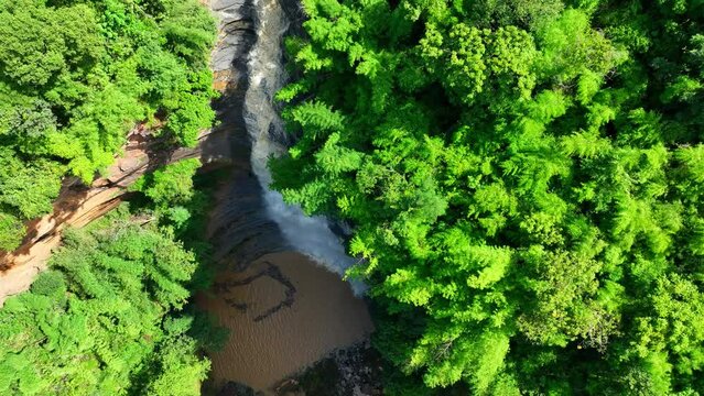 Tad Yai Waterfall: Thailand's tallest and most elegant waterfall, its beauty enhanced by shale rocks and gray-black mudstone, a must-visit during the flood season. Drone aerial view. Nature concept.
