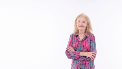 Satisfied healthy 70s cheerful grandmother confident arms crossed successful standing over isolated white background. Friendly positive retired elderly woman arms crossed looking camera copy space.