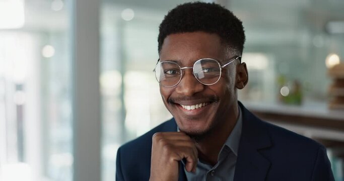 Face, young businessman and glasses in office with confident and positive attitude for startup at work. Employee, professional and portrait of entrepreneur and happy or smile for career in accounting