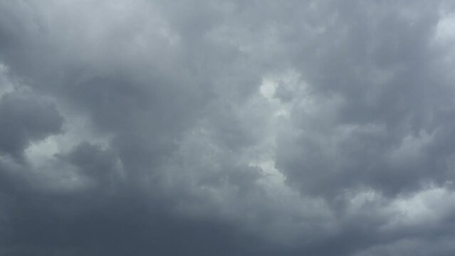 Sky and gray clouds. Puffy fluffy dark clouds. Cumulus cloud cloudscape time lapse. Autumn or winter sky time lapse. Nature weather forecast. Rainy clouds background. Cloud dramatic rapid video storm.