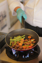 chef stir-fries nuggets and long beans