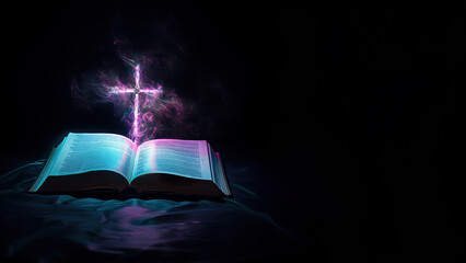Open bible with a glowing cross in a black background with copyspace for text