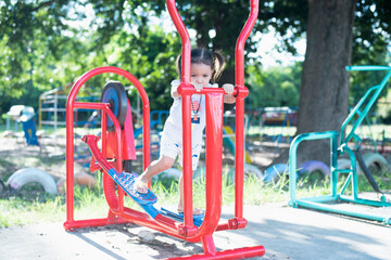 Fototapeta na wymiar Children playing on a summer day Playground in the park Children's entertainment and recreation.