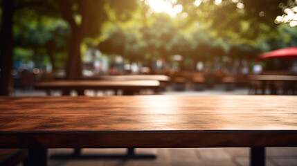 Empty wooden table of a summer cafe on a background of beautiful green trees