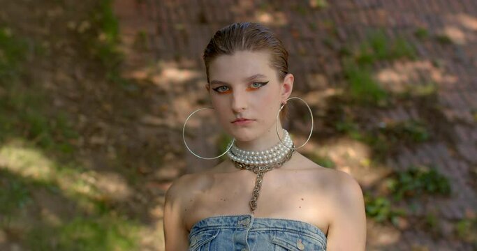 Portrait of young woman looking into camera. Personal style elements of current fashion trends includes a unique twist or interpretation sets it apart from mainstream fashion. Signature Pieces