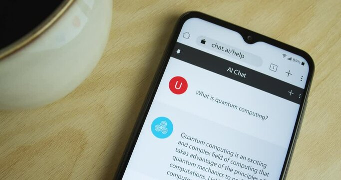 Artificial Intelligence - AI chat bot app on smartphone - Royalty free phone and app interface - Close shot, coffee - 
"What is quantum computing?"