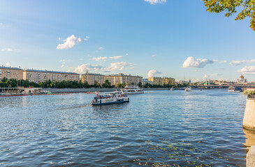 Fototapeta premium Cruise ship sails on the Moscow river in Moscow city center, popular place for walking.