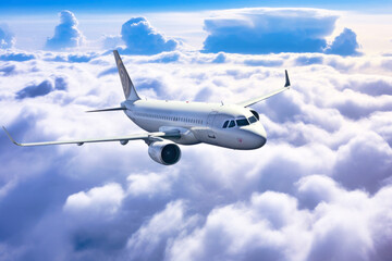 Fototapeta na wymiar Passenger plane flying over clouds, sunny day