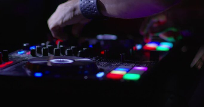 DJ Mixing in club booth and Colorful CD Turntable