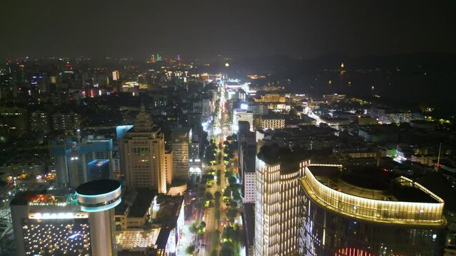 Nighttime Drone Journey Along Downtown Hangzhou, City Lights and High Rises. China