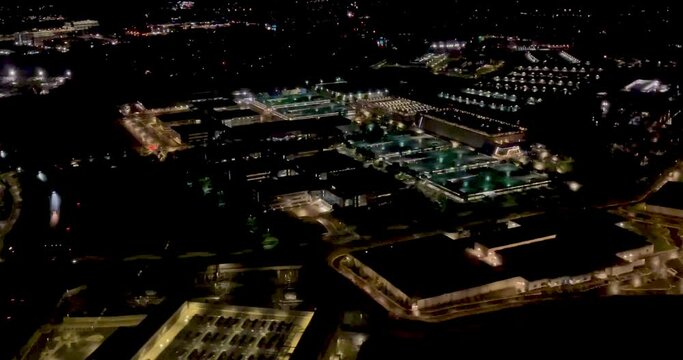 A 4K night shot from a plane on approach to Washington Dulles Airport  USA located in Virginia showing flood lighted buildings 26 miles from Washington DC