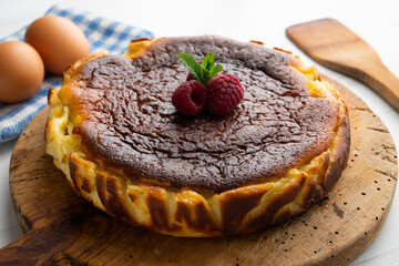 Traditional cheesecake decorated with raspberries.