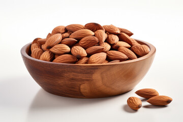 Wooden bowl filled with almonds on white surface. Suitable for healthy eating and snack concepts.