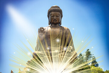 The Tian Tan Buddha in Hong Kong, with a radiant glow above and in front of the statue